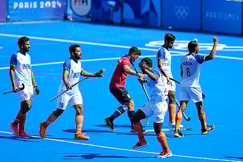 India's players celebrate after winning the men's bronze medal field hockey match against Spain